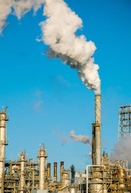 smoke stacks emitting carbon pollution into the sky causing climate change