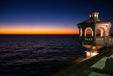 The Golden Hour Right before sunrise along Corpus Christi , Texas with gazebo along the sea wall of Gulf of Mexico