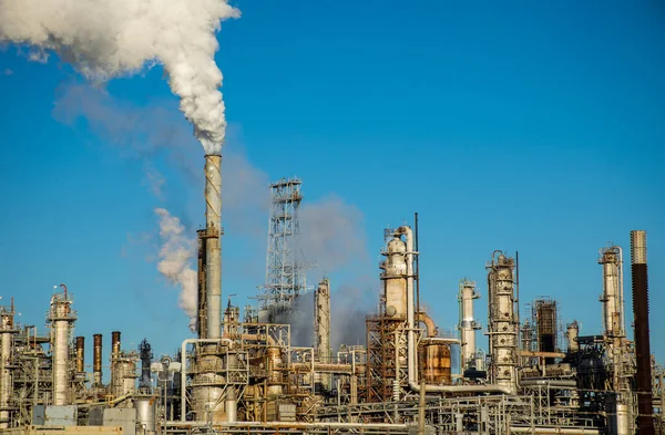 smoke stacks emitting carbon pollution into the sky causing climate change