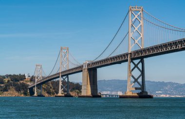 Oakland 'dan San Francisco Körfez Köprüsü' ne kadar olan uzun altyapı planı güneşli bir öğleden sonra Kaliforniya, San Francisco sahilinde büyük bir asma köprü ile Bay Area 'yı geçiyor.