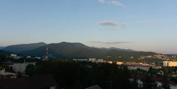 LAZAREVSKOE, SOCHI, RUSSIA - MAY, 27, 2021: Panorama of sunset in the mountains. A magical view of the sea and small town from the observation deck — Stock Photo, Image