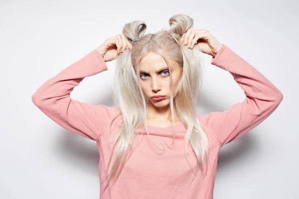 Pretty Blonde Girl Holding She Hair Buns White Studio Background — Stock Photo, Image