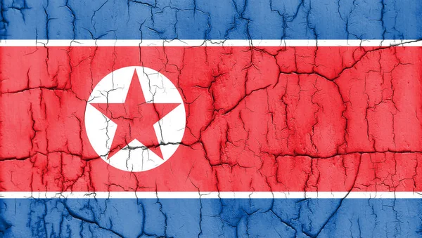 Textured photo of the flag of North Korea with cracks.