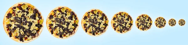 Close-up of vegan pizza from small to big on blue background. Panoramic banner.