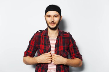 Studio portrait of young confident guy on white background.