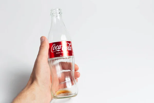 Close Male Hand Holding Empty Glass Bottle Coca Cola White — ストック写真