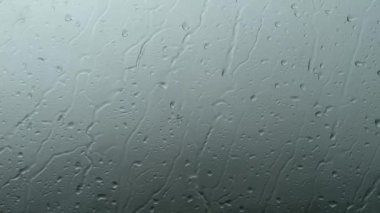 Heavy rain is pouring down the window. Natural background.
