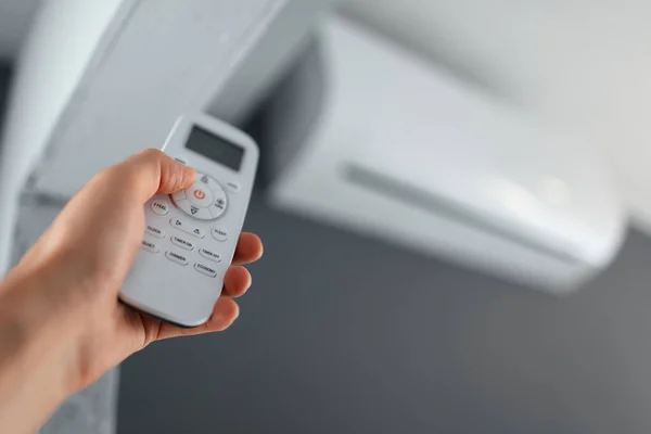 Close Male Hand Using Remote Control Air Conditioner — Stockfoto