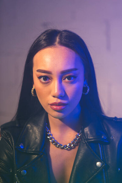 Beautiful girl with Asian looks and neon lights