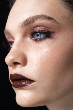 Güzel ve alışılmadık makyajlı bir kızın portresi.