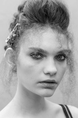 Saçları ve makyajı olan güzel bir kızın geçmişe dönük portresi.