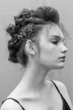 Saçları ve makyajı olan güzel bir kızın geçmişe dönük portresi.