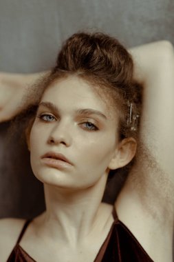 Saçları ve makyajı olan güzel bir kızın geçmişe dönük portresi.