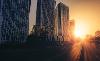 Beautiful view of the highway and skyscrapers against a golden sunset