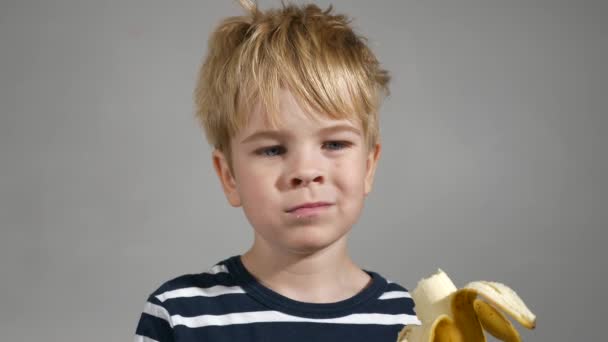 Happy Child Enjoys Eating Tasty Banana Portrait Cute Little Boy — Stock Video