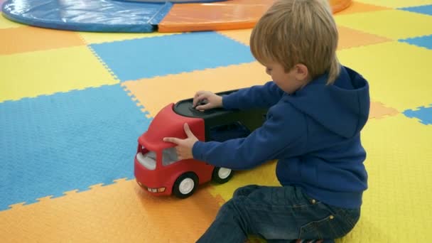 Cute Child Boy Plays Alone Indoor Kids Playground Children Playroom — Stock Video