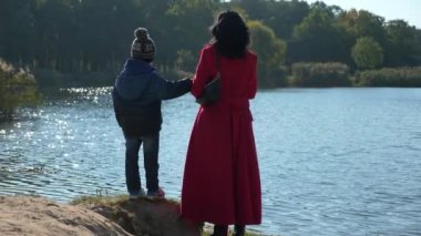 Anne şovu oğluna şehir parkındaki doğa koşullarından bahset. Kadın Çocuk Çocukla Dinlen. Güneşli bir gün. 2x Yavaş çekim 60fps 4K