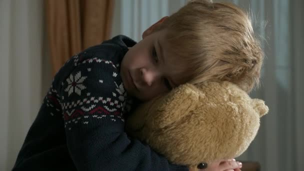 Sad Little Boy Sits Hugging Teddy Bear Toy Lonely Kid — Stock Video