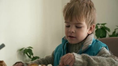 Child Eat Rice with Canned Corn. Kid Eating Meal Breakfast Dinner at Kitchen Table. Winter Day. Close-up. 2x Slow motion 60fps 4K