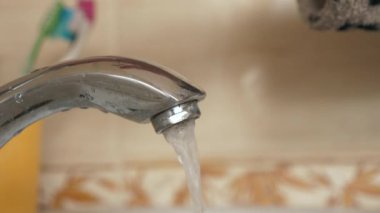 Woman Washes Female Hands with Water Under Tap in Bathroom. Hygiene Close-up. Slow motion 4K