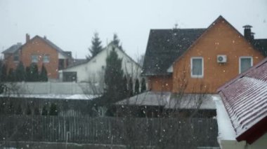 Kar fırtınası tipi. Snow Covered Backyard Cottage Houses Village Country 'nin penceresinden bak. Kış Sezonu Akşam Arkaplanı. Yavaş çekim 4K