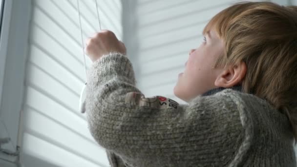 Little Boy Kid Opens Window Roller Shutter Blinds Curtain Cute — 图库视频影像