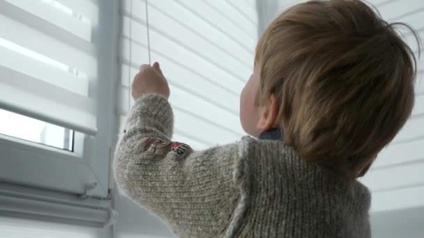 Little Boy Kid Opens Window Roller Shutter Blinds Curtain Cute — Vídeo de Stock