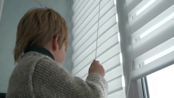 Little Boy Kid Opens Window Roller Shutter Blinds Curtain Cute — 图库视频影像