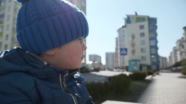 Lonely Little Boy Sits Bench City Street Waiting Parents Warm — Stock Video