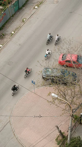 Top view of five amateur cyclists riding the bikes on the street