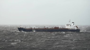Handysize oil tanker underway in rough seas in the North sea