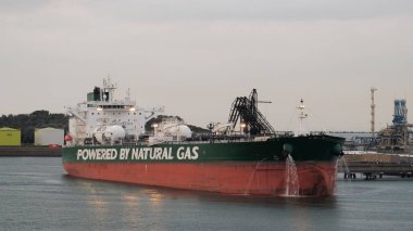 LNG-powered oil tanker in ballast during cargo operations in the European port