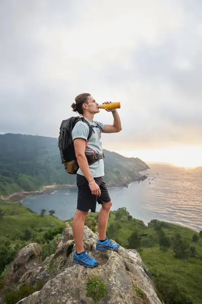Side View Male Hiker Standing Stone Drinking Water Background Sunset — Stock Photo, Image