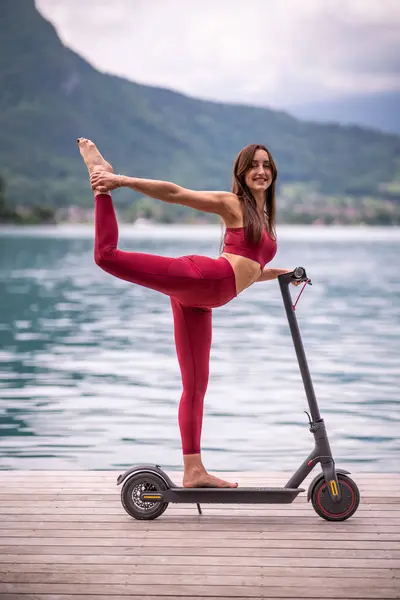 Side View Delighted Flexible Female Activewear Balancing Natarajasana Electric Scooter — Stockfoto