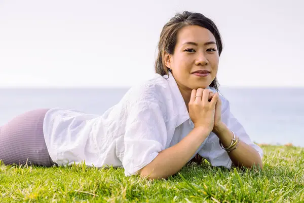 Sincere Young Ethnic Female Casual Wear Looking Camera While Lying — Stock Photo, Image