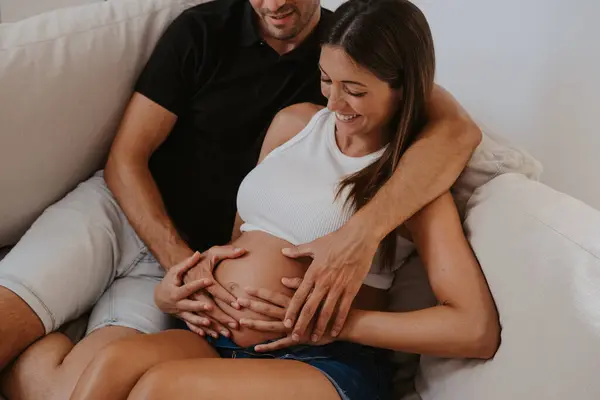 Cropped Man Embracing Belly Expectant Female Beloved While Resting Couch — Stock Photo, Image