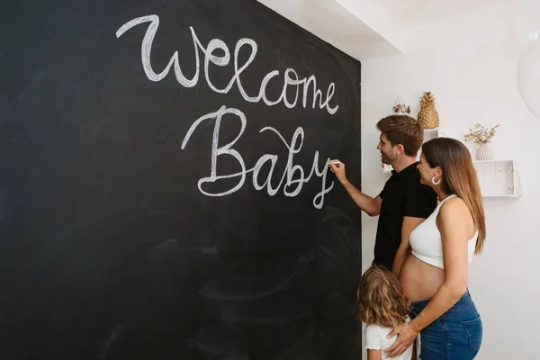 Escrita Masculina Welcome Baby Inscrição Quadro Negro Contra Expectante Fêmea — Fotografia de Stock