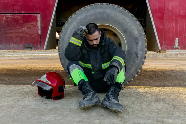 Exhausted Male Firefighter Wearing Uniform Sitting Ground Fire Engine Red — Stock Photo, Image