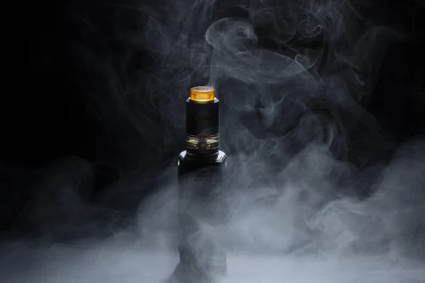 Vape close-up in a smoke on a black background — Stock Photo, Image