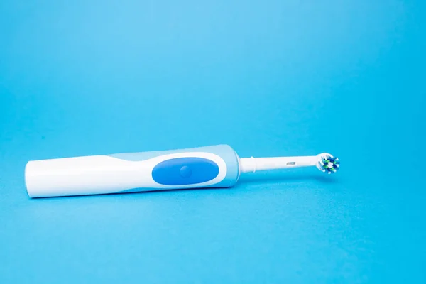 Smart electric toothbrush on a blue isolated background. — Stock Photo, Image