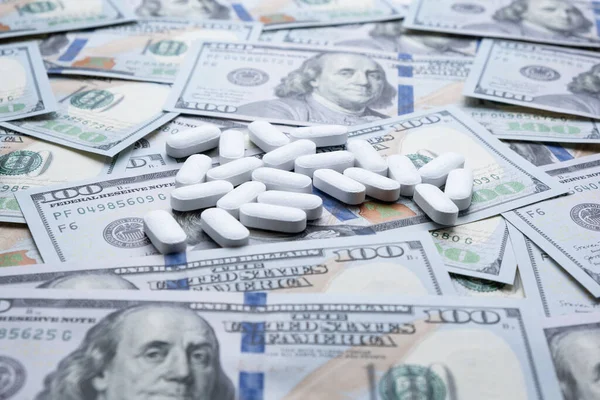 Pills on the background of the dollar close-up. Stock Image