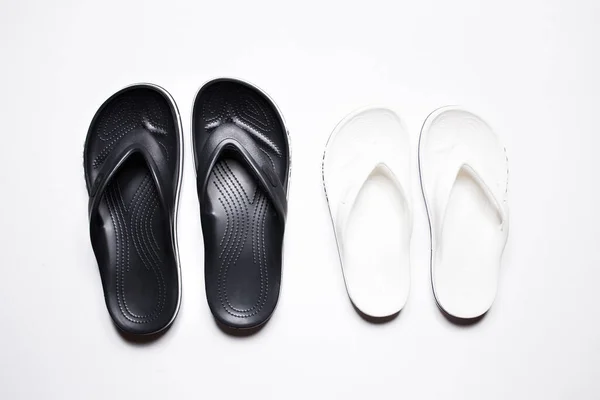 Flip Flops on a white isolated background. Black male and female white. — Foto de Stock