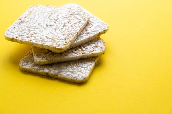 Rice cake on a yellow background close-up.