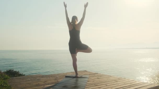 Young Woman Practices Yoga Background Sea Summer Day — Stockvideo