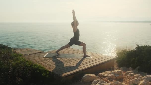 Young Woman Practices Yoga Background Sea Summer Day — Stockvideo