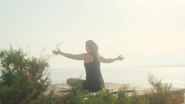 Young Woman Practices Yoga Background Sea Summer Day — Stockvideo