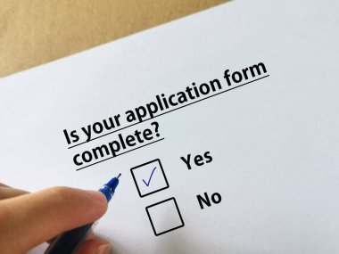 Bir kişi işle ilgili soruya cevap veriyor. Başvuru formunun tamamlandığını düşünüyor..