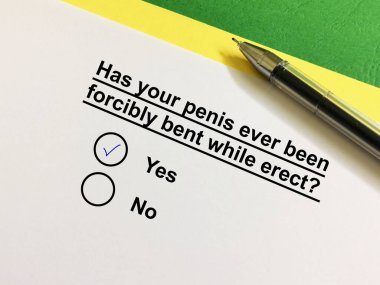 One person is answering question about erectile dysfunction. The person has his penis forcibly bent while erect.