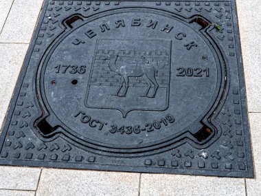 cover of the well with the coat of arms of the city of Chelyabinsk in the form of a camel and the inscription - GOST, Chelyabinsk