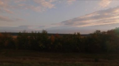 View from the train window at sunset time in autumn. High quality FullHD footage